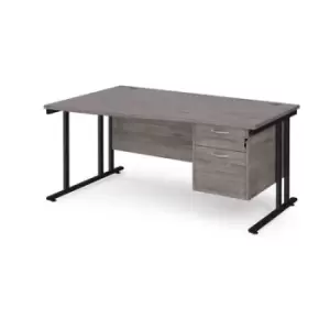 image of Maestro 25 left hand wave desk 1600mm wide with 2 drawer pedestal - Black cantilever leg frame and grey oak top