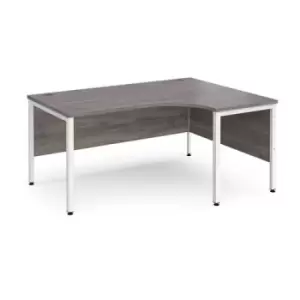 Image of Maestro 25 right hand ergonomic desk 1600mm wide - white bench leg frame and grey oak top