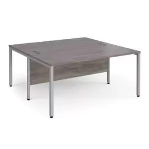 image of Maestro 25 back to back straight desks 1600mm x 1600mm - silver bench leg frame and grey oak top