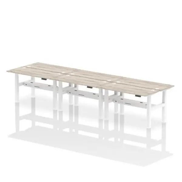 Image of Air Air Back-to-Back 1400 x 600mm Height Adjustable 6 Person Bench Desk Grey Oak Top with Cable Ports White Frame HASCP6P14600GRYW