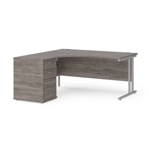 image of Maestro 25 left hand ergonomic desk 1600mm with silver cantilever frame and desk high pedestal - grey oak