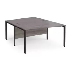 Image of Maestro 25 back to back wave desks 1400mm deep - Black bench leg frame and grey oak top
