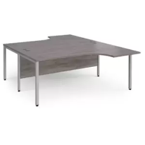 image of Maestro 25 back to back ergonomic desks 1800mm deep - silver bench leg frame and grey oak top