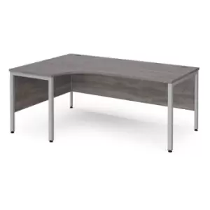 image of Maestro 25 left hand ergonomic desk 1800mm wide - silver bench leg frame and grey oak top