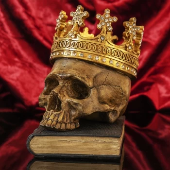 Image of Hand Painted Skull with Crown Resting On A Book Ornament