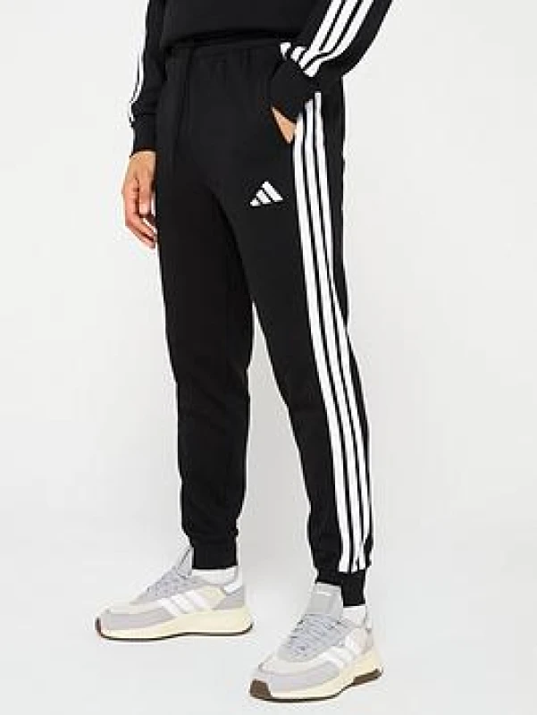 Image of adidas Essentials Fleece Tapered Cuff 3-Stripes Joggers Closed Hem Fleece Jogging Bottoms S Black 48702603350