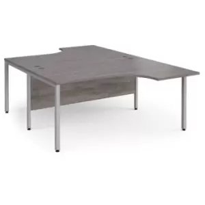 image of Maestro 25 back to back ergonomic desks 1600mm deep - silver bench leg frame and grey oak top