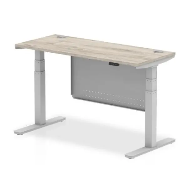 image of Air 1400 x 600mm Height Adjustable Desk Grey Oak Top Cable Ports Silver Leg With Silver Steel Modesty Panel