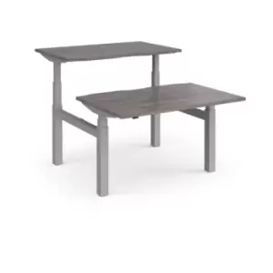 image of Elev8 Touch sit-stand back-to-back desks 1200mm x 1650mm - silver frame and grey oak top