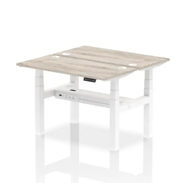 Image of Air Air Back-to-Back 1200 x 600mm Height Adjustable 2 Person Bench Desk Grey Oak Top with Cable Ports White Frame HASCP2P12600GRYW