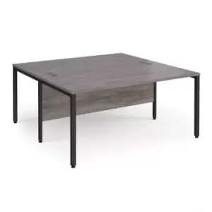 Image of Maestro 25 back to back straight desks 1600mm x 1600mm - Black bench leg frame and grey oak top