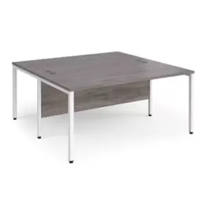 Image of Maestro 25 back to back straight desks 1600mm x 1600mm - white bench leg frame and grey oak top