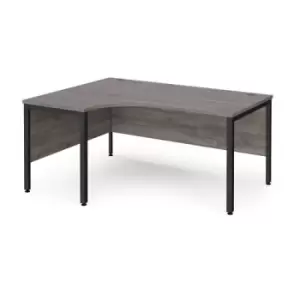 image of Maestro 25 left hand ergonomic desk 1600mm wide - Black bench leg frame and grey oak top