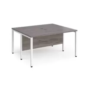 image of Maestro 25 back to back straight desks 1400mm x 1200mm - white bench leg frame and grey oak top