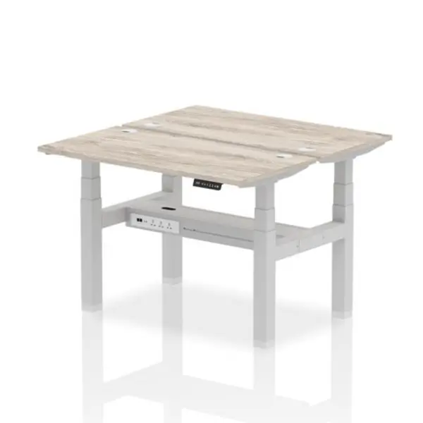 Image of Air Air Back-to-Back 1200 x 600mm Height Adjustable 2 Person Bench Desk Grey Oak Top with Cable Ports Silver Frame HASCP2P12600GRYS