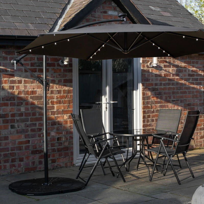 Image of Outdoor 4 Person Round Glass Top Garden Dining Table Chairs With Black Banana Lit Parasol and Base Set