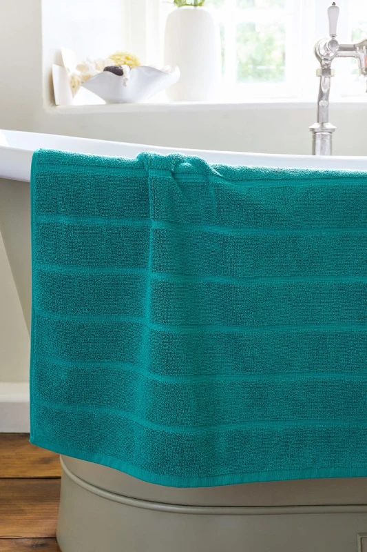 Image of Christy CHRISTY 'Signum' Heavyweight 100% Combed Cotton Bath Mat in Teal Teal One Size Unisex 5057241204679
