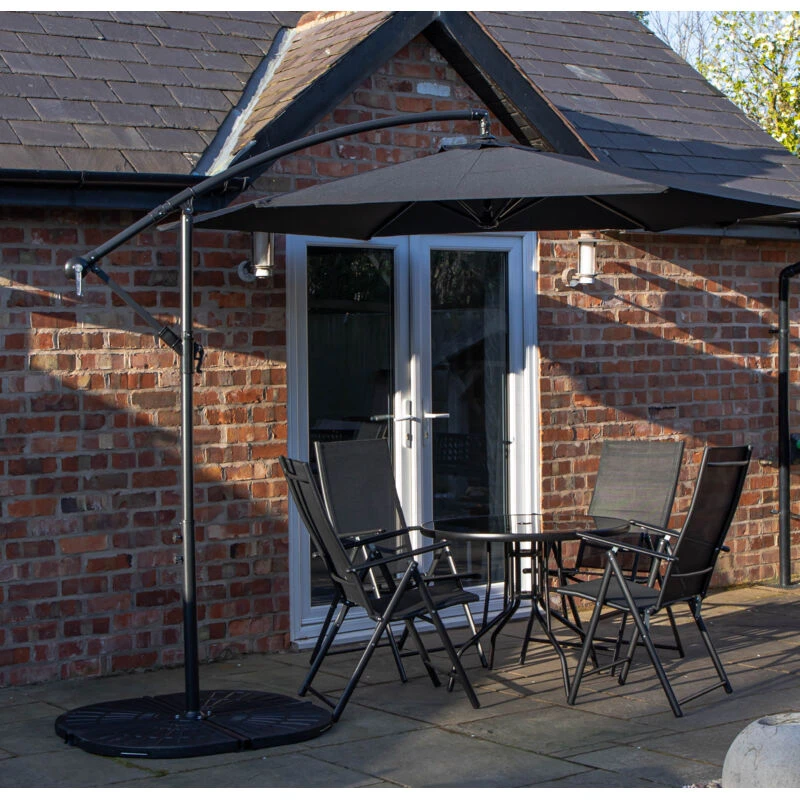 Image of Samuel Alexander Outdoor 4 Person Round Glass Top Garden Dining Table Chairs With Banana Parasol & Base in Black Unisex 4 Person
