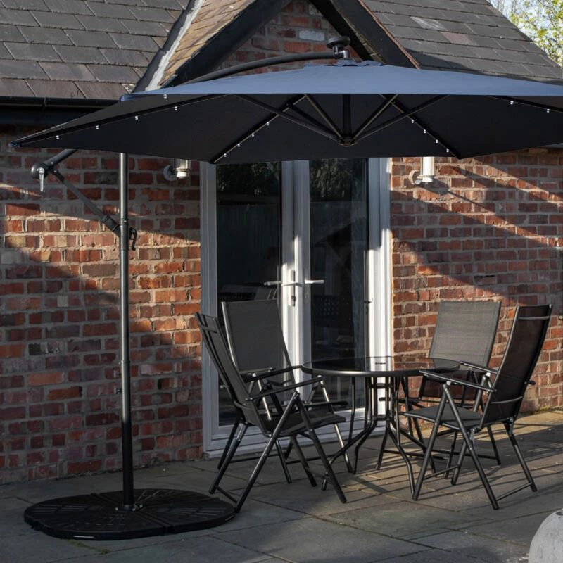 Image of Outdoor 4 Person Round Glass Top Garden Dining Table Chairs With Blue Banana Lit Parasol and Base Set