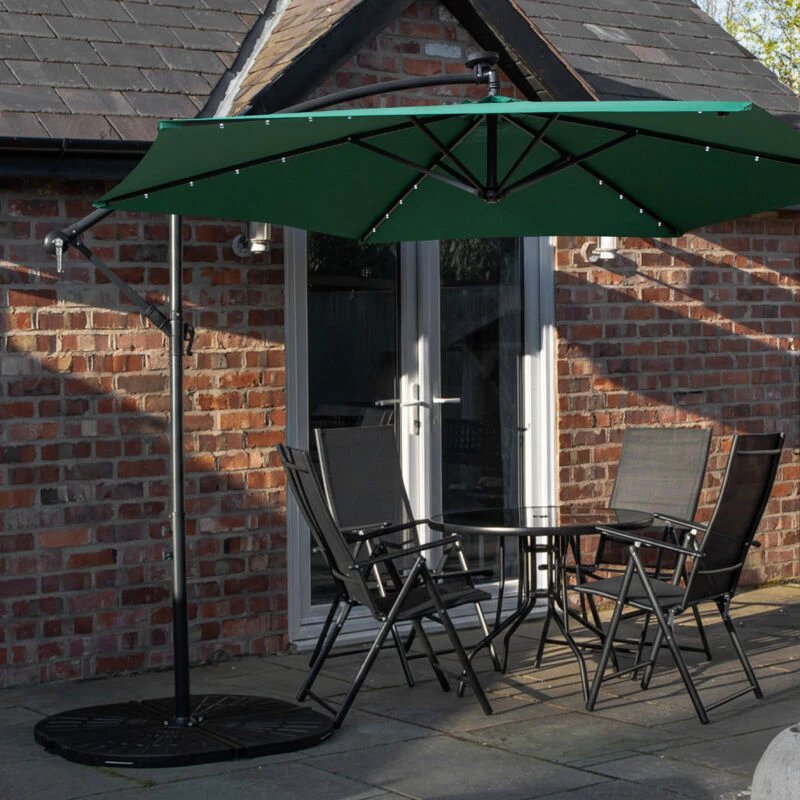Image of Outdoor 4 Person Round Glass Top Garden Dining Table Chairs With Green Banana Lit Parasol and Base Set