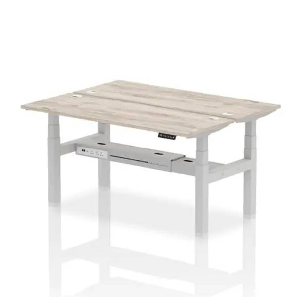 Image of Air Air Back-to-Back 1600 x 600mm Height Adjustable 2 Person Bench Desk Grey Oak Top with Cable Ports Silver Frame HASCP2P16600GRYS