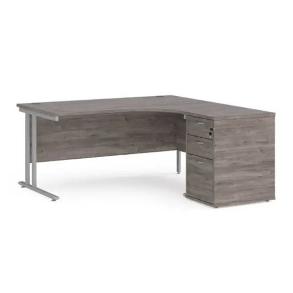 Image of Maestro 25 right hand ergonomic desk 1600mm with silver cantilever frame and desk high pedestal - grey oak