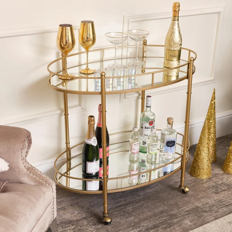 Image of Melody Maison Gold Mirrored Oval Drinks Trolley Gold